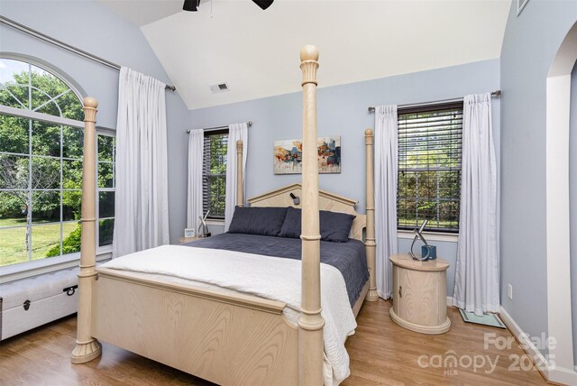 14807 Middlesborough Dr, Matthews, NC 28104 - bedroom with light wood-style flooring, lofted ceiling, ceiling fan, arched walkways, and baseboards