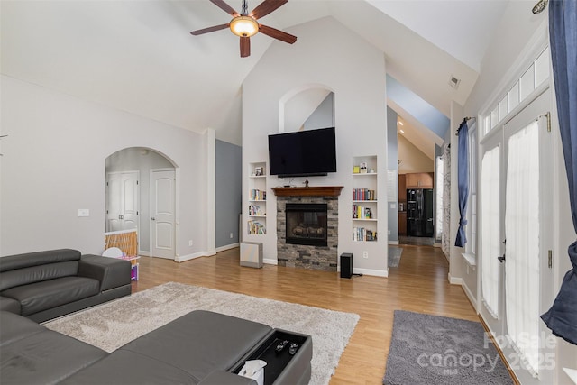 14807 Middlesborough Dr, Matthews, NC 28104 - living area featuring high vaulted ceiling, ceiling fan, light wood-style floors, a fireplace, and built in features