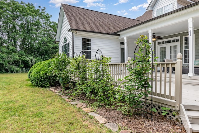 14807 Middlesborough Dr, Matthews, NC 28104 - view of side of home with roof with shingles, a ceiling fan, a yard, and french doors
