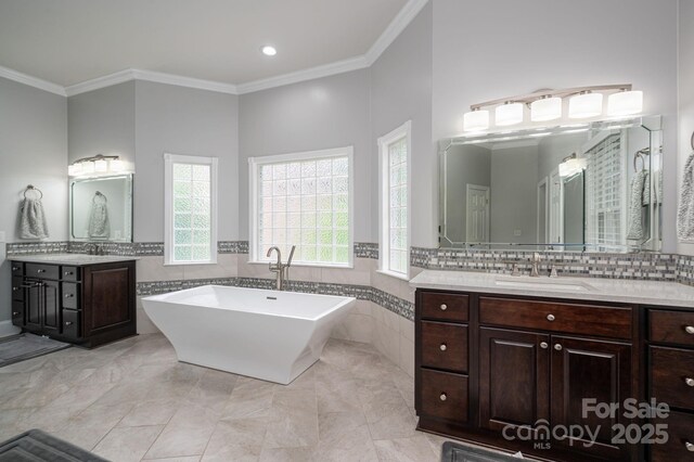 bathroom with a sink, tile walls, and crown molding