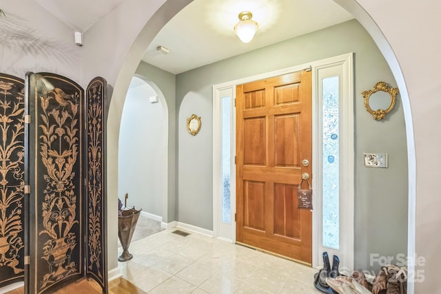 3585 Goodman Lake Rd, Salisbury, NC 28146 - foyer entrance with light tile patterned floors, baseboards, and arched walkways