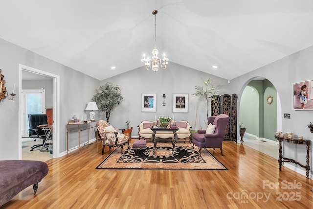 3585 Goodman Lake Rd, Salisbury, NC 28146 - living room featuring wood finished floors, baseboards, a chandelier, and arched walkways