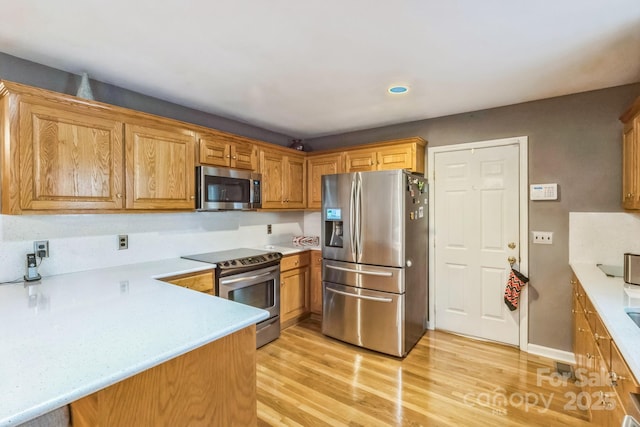 3585 Goodman Lake Rd, Salisbury, NC 28146 - kitchen with recessed lighting, stainless steel appliances, light countertops, light wood finished floors, and baseboards