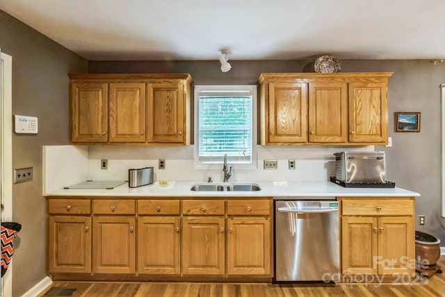 3585 Goodman Lake Rd, Salisbury, NC 28146 - kitchen featuring a sink, brown cabinetry, light countertops, stainless steel dishwasher, and wood finished floors