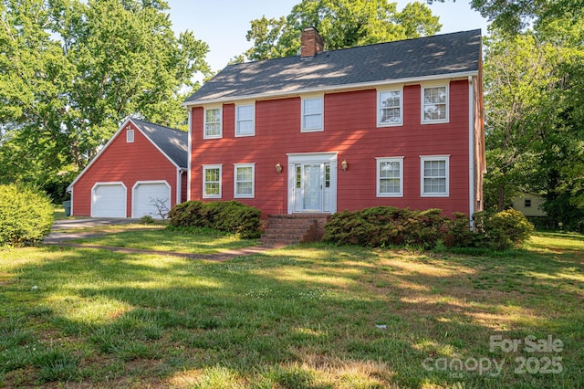 colonial home with a chimney and a front yard