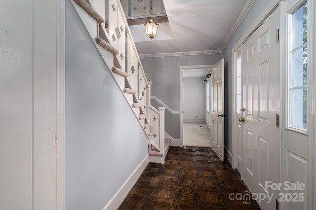 foyer with baseboards, stairs, and plenty of natural light