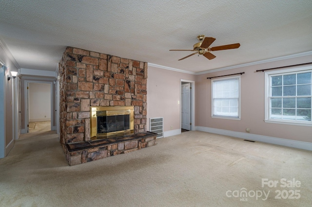 unfurnished living room featuring a ceiling fan, visible vents, a stone fireplace, and carpet