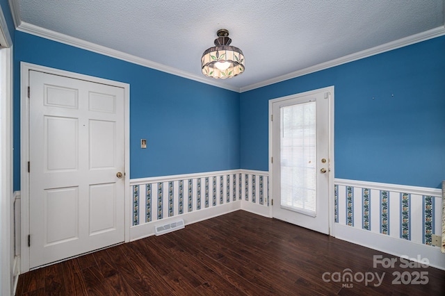 interior space with visible vents, a textured ceiling, crown molding, and wood finished floors