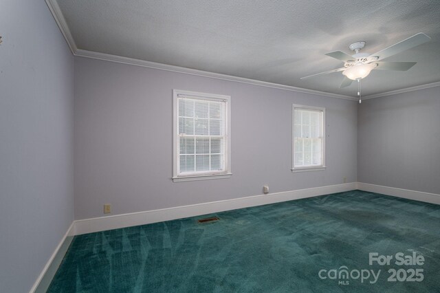 carpeted empty room featuring a ceiling fan, baseboards, visible vents, and ornamental molding
