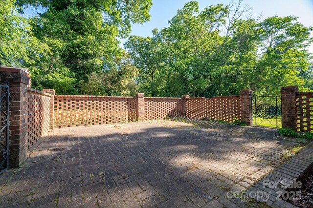 view of patio with fence and a gate