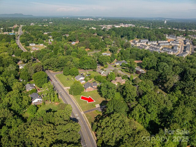 birds eye view of property with a view of trees