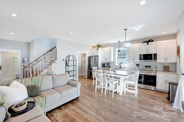 7 Mountain View Ave, Black Mountain, NC 28711 - living area featuring recessed lighting, light wood-style floors, and stairway