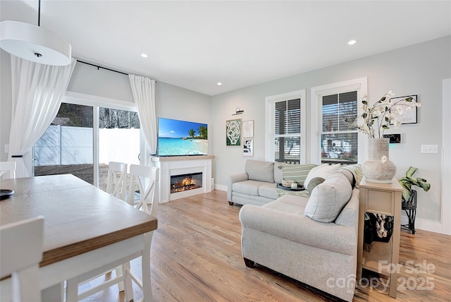 7 Mountain View Ave, Black Mountain, NC 28711 - living room featuring plenty of natural light, wood finished floors, a glass covered fireplace, and recessed lighting
