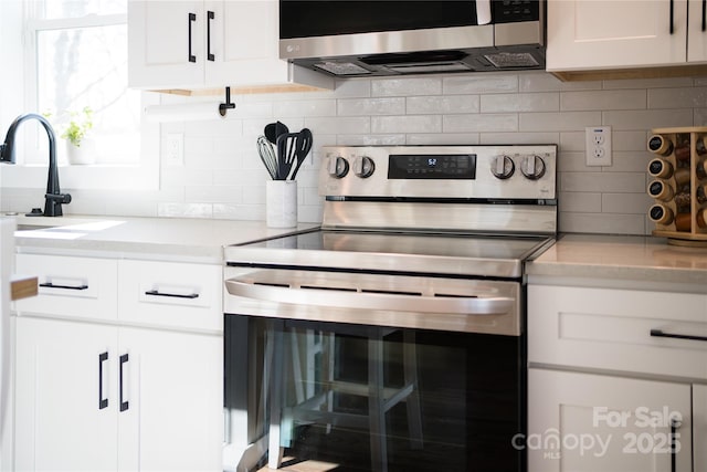 7 Mountain View Ave, Black Mountain, NC 28711 - kitchen featuring appliances with stainless steel finishes, decorative backsplash, and white cabinets