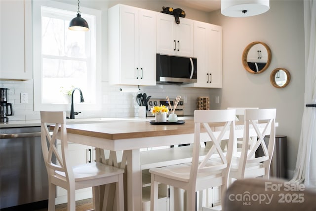 7 Mountain View Ave, Black Mountain, NC 28711 - kitchen featuring dishwasher, decorative backsplash, light countertops, and white cabinetry