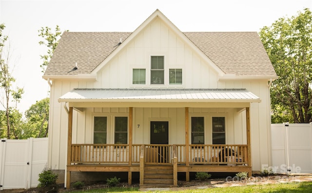 7 Mountain View Ave, Black Mountain, NC 28711 - view of front facade with board and batten siding, roof with shingles, covered porch, and a gate