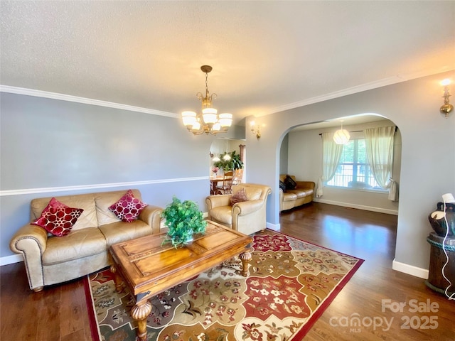 970 Mt Moriah Church Rd, China Grove, NC 28023 - living area featuring crown molding, arched walkways, wood finished floors, baseboards, and a notable chandelier