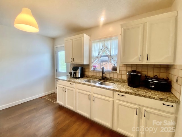 970 Mt Moriah Church Rd, China Grove, NC 28023 - kitchen with decorative backsplash, dark wood-style flooring, baseboards, light stone counters, and a sink