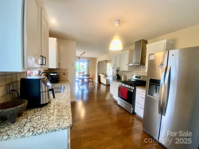 970 Mt Moriah Church Rd, China Grove, NC 28023 - kitchen with white cabinets, stainless steel appliances, backsplash, and wall chimney exhaust hood