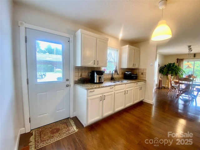 970 Mt Moriah Church Rd, China Grove, NC 28023 - kitchen with dark wood-type flooring, a sink, white cabinets, and tasteful backsplash