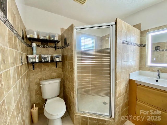 970 Mt Moriah Church Rd, China Grove, NC 28023 - bathroom with visible vents, tile walls, a shower stall, vanity, and toilet