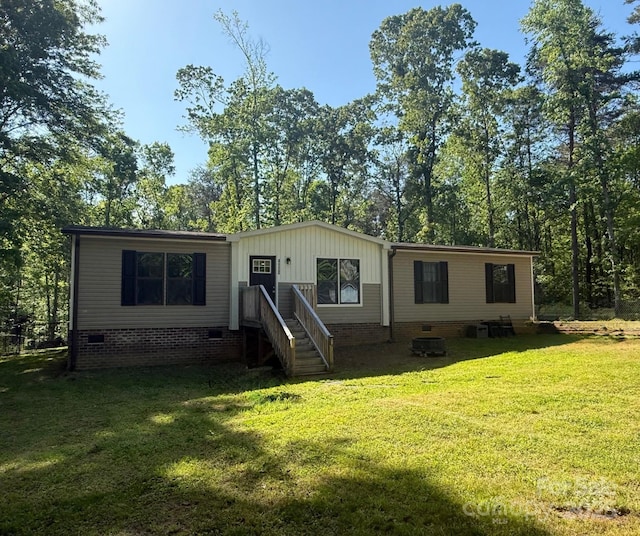 manufactured / mobile home featuring a front yard and crawl space