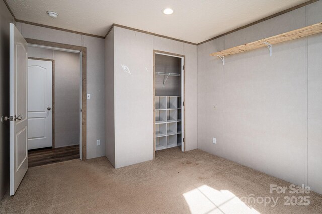 unfurnished bedroom featuring recessed lighting, carpet, and crown molding