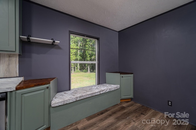 bedroom with a textured ceiling and dark wood-type flooring