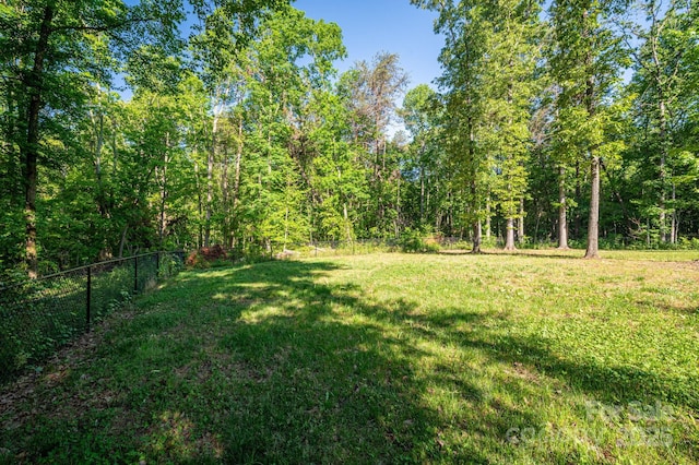 view of yard with a view of trees