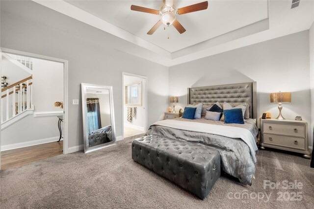 3588 County Down Ave, Kannapolis, NC 28081 - carpeted bedroom with a tray ceiling, baseboards, a ceiling fan, and connected bathroom