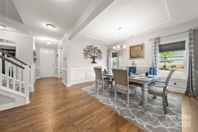 3588 County Down Ave, Kannapolis, NC 28081 - dining room with a chandelier, wood finished floors, stairs, wainscoting, and ornamental molding