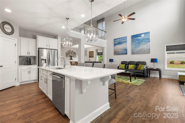 3588 County Down Ave, Kannapolis, NC 28081 - kitchen featuring appliances with stainless steel finishes, open floor plan, a sink, white cabinetry, and recessed lighting