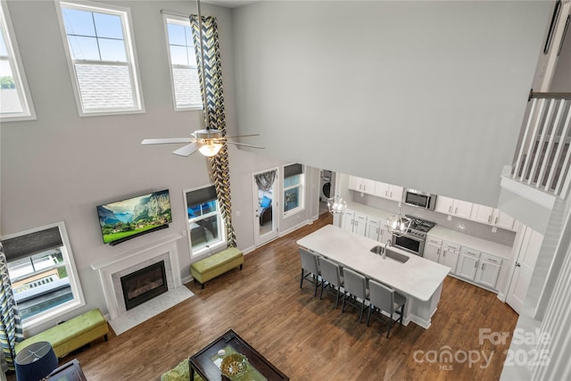 3588 County Down Ave, Kannapolis, NC 28081 - living room with dark wood-type flooring, a fireplace with flush hearth, and a ceiling fan