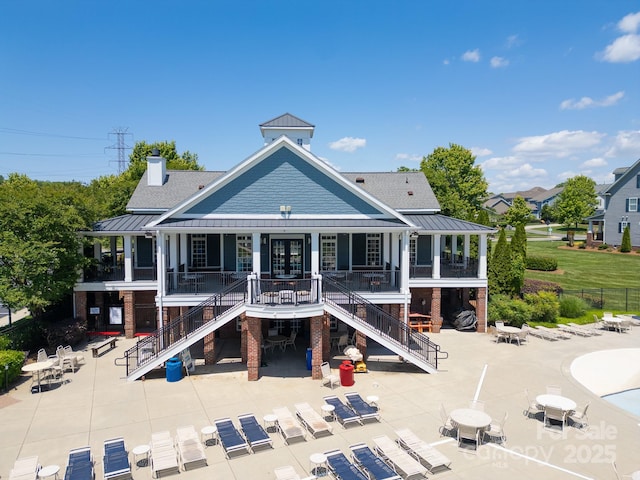 3588 County Down Ave, Kannapolis, NC 28081 - rear view of property featuring stairway, a standing seam roof, and a patio area