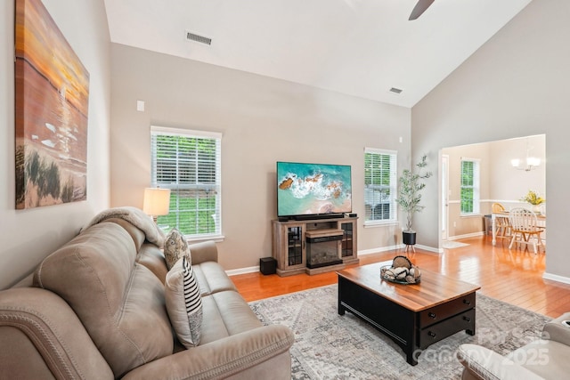 3032 Kilbeggan Dr, Clover, SC 29710 - living room featuring wood finished floors, high vaulted ceiling, baseboards, a chandelier, and a ceiling fan