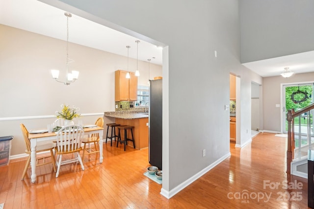 3032 Kilbeggan Dr, Clover, SC 29710 - dining area with light wood-style floors, a chandelier, and baseboards