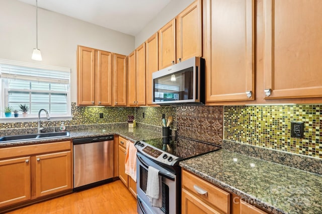 3032 Kilbeggan Dr, Clover, SC 29710 - kitchen featuring stainless steel appliances, a sink, light wood-style flooring, and backsplash