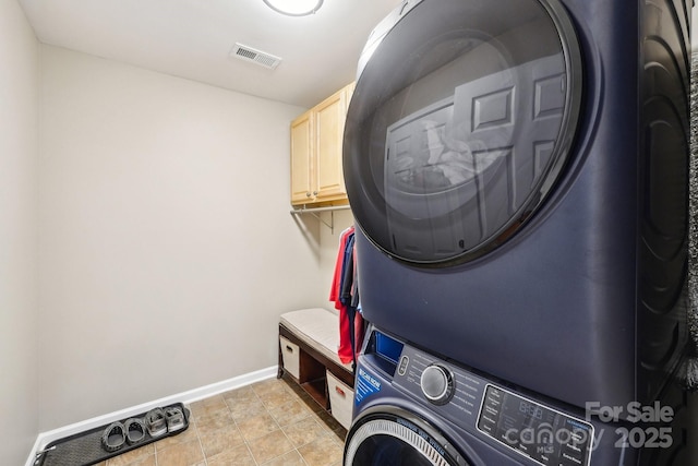 3032 Kilbeggan Dr, Clover, SC 29710 - laundry area featuring stacked washer / dryer, baseboards, and cabinet space