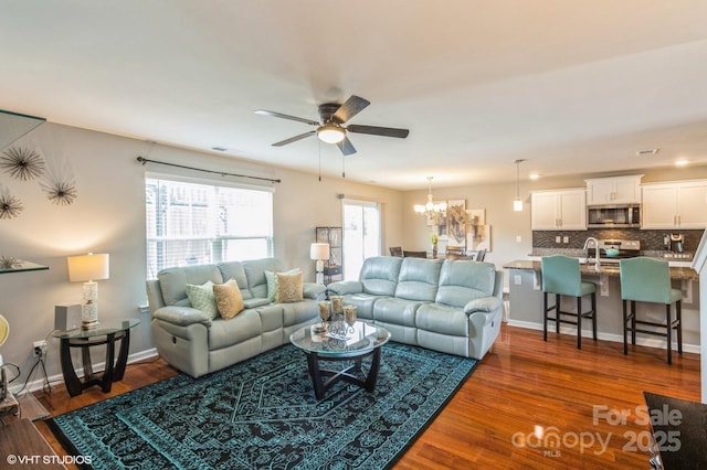 2772 Sherrills Stream Dr, Sherrills Ford, NC 28673 - living room featuring a ceiling fan, dark wood-style floors, a chandelier, and baseboards