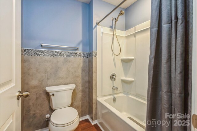 2772 Sherrills Stream Dr, Sherrills Ford, NC 28673 - full bath featuring tile walls, shower / tub combo, toilet, a wainscoted wall, and wood finished floors