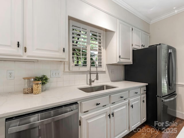 232 Perrin Pl, Charlotte, NC 28207 - kitchen featuring appliances with stainless steel finishes, a sink, white cabinets, decorative backsplash, and ornamental molding