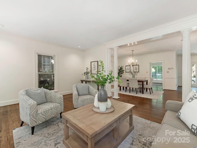 232 Perrin Pl, Charlotte, NC 28207 - living area featuring decorative columns, ornamental molding, wood finished floors, and a chandelier