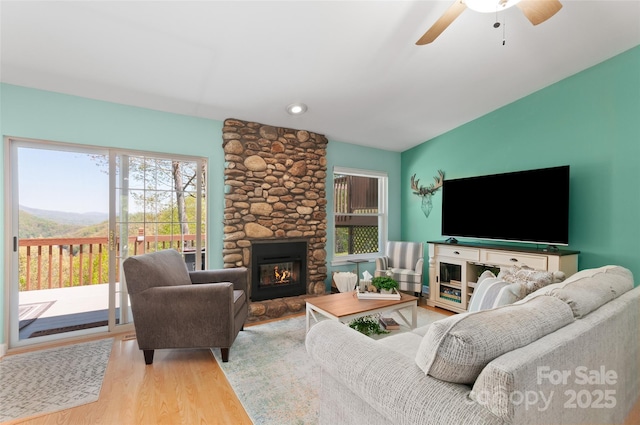 living room featuring recessed lighting, a ceiling fan, wood finished floors, and a fireplace