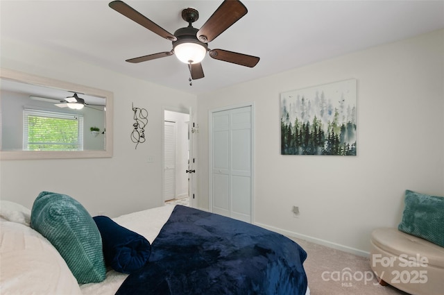 bedroom featuring baseboards, ceiling fan, and carpet flooring