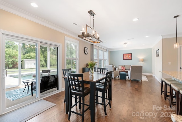 dining space featuring crown molding, recessed lighting, and dark wood-type flooring