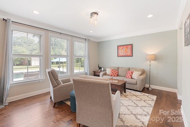 living room featuring crown molding, baseboards, and plenty of natural light