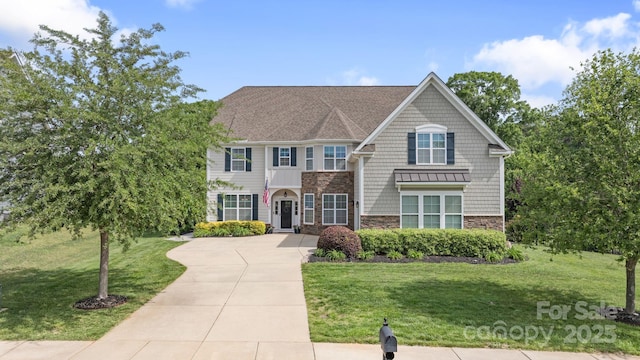 view of front of house with a front lawn and stone siding