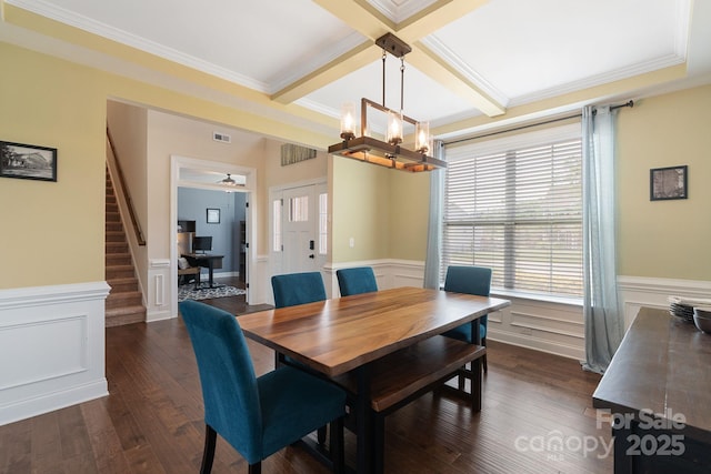 dining space with beam ceiling, ornamental molding, coffered ceiling, stairs, and dark wood-type flooring