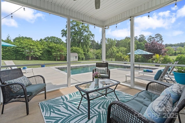 sunroom featuring ceiling fan, a wealth of natural light, and an outdoor hangout area