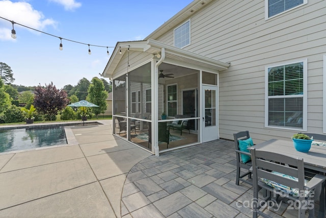 view of patio / terrace with ceiling fan, a sunroom, and an outdoor pool